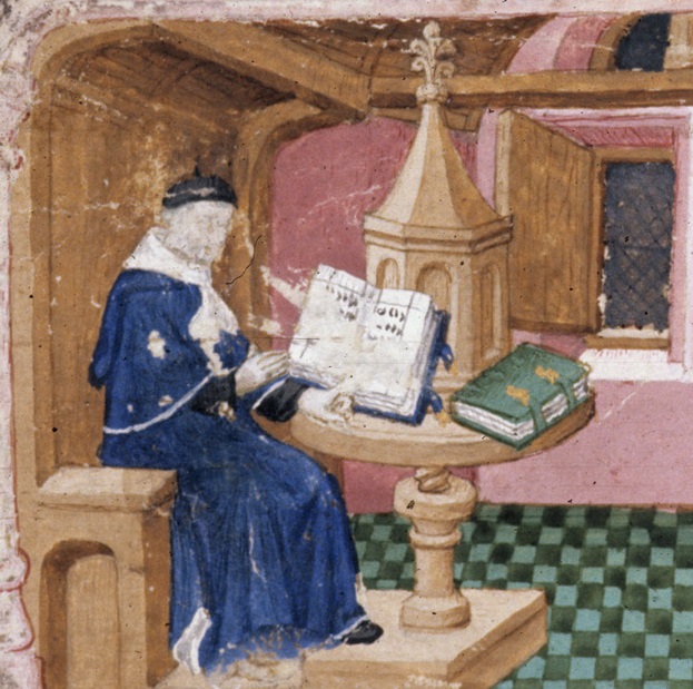 A man in a robe sits in an armchair with a circular table in front of him. The table rotates on a screw joint and supports two books, one open and upright and one horizontal and closed. In the background a glass window shows a dark night.