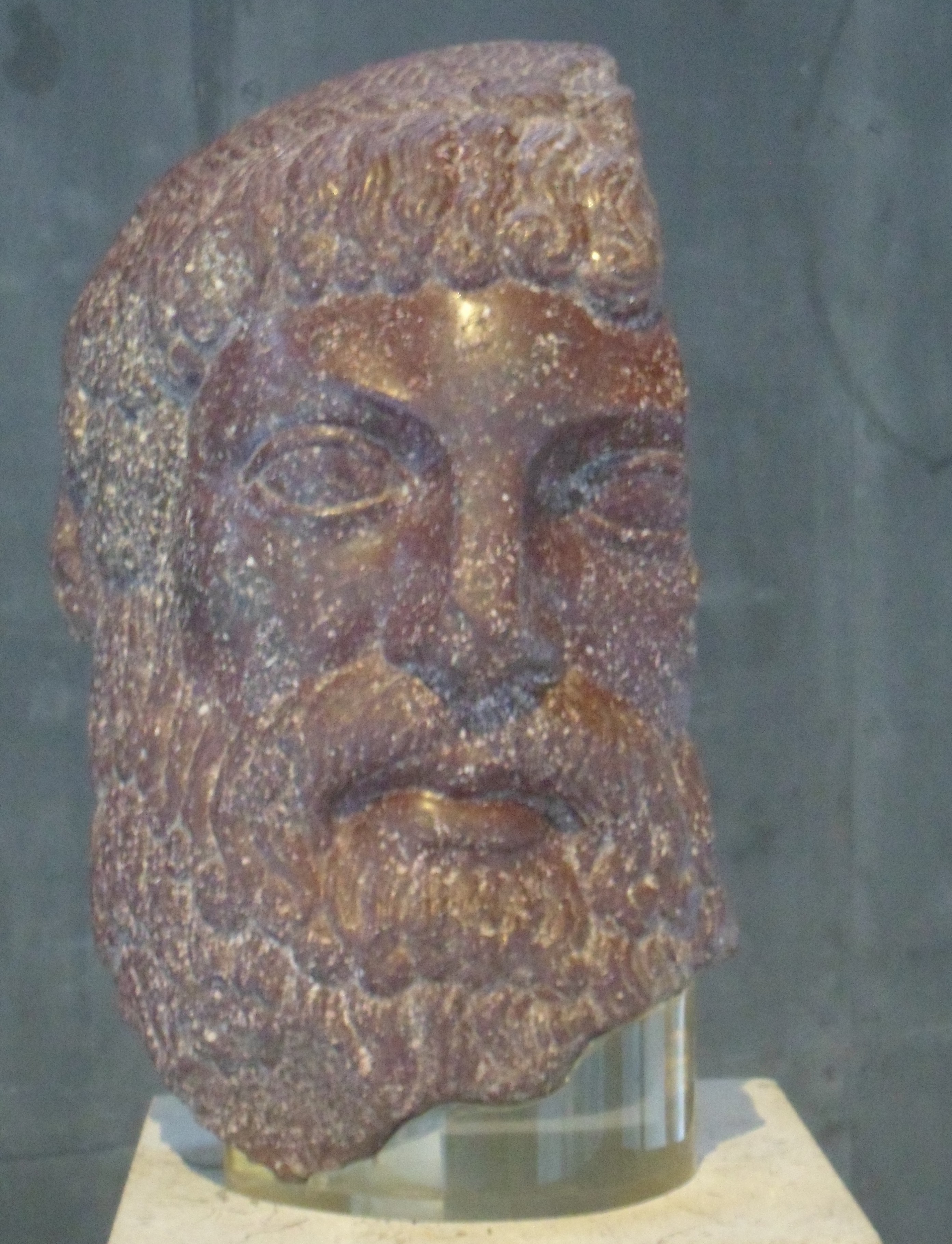 Life-sized head of a bearded man carved of smooth stone