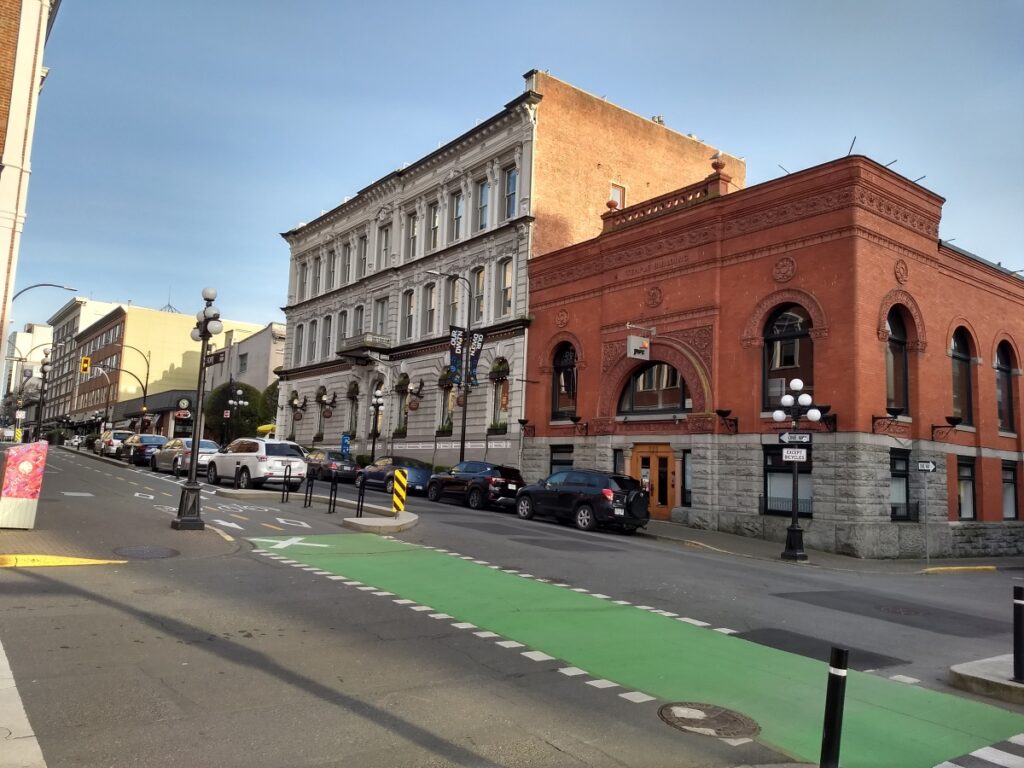 a Victoria, BC street scene with a brick building and a brick building with a stone facade