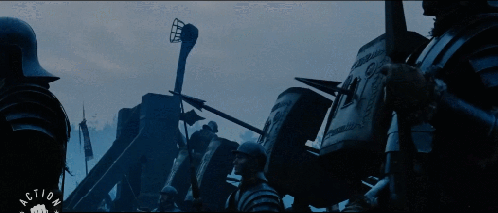 a photo of two catapults loaded with bolts and one one-armed catapult with a fixed basket for throwing pots. The scene is mostly blue, grey, and black.