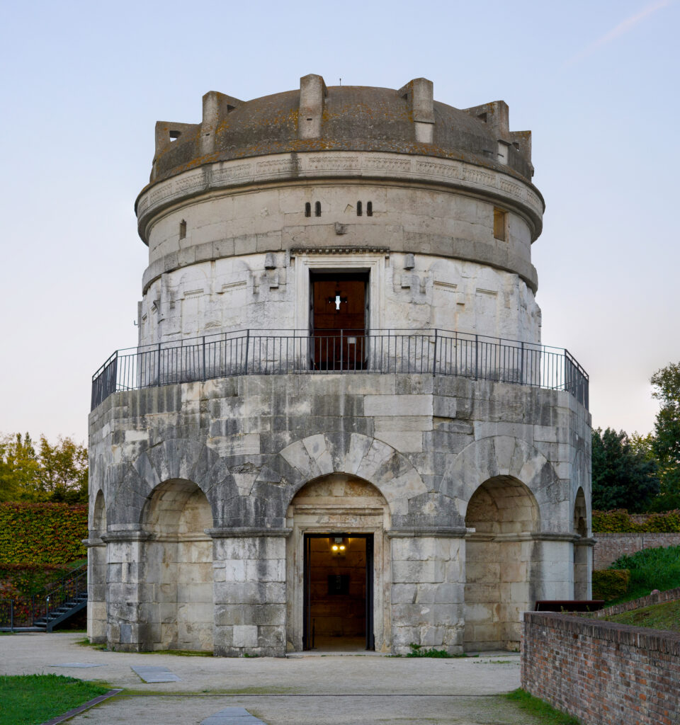 a photo of a tall round stone building with a low domed roof silhouetted against the sky